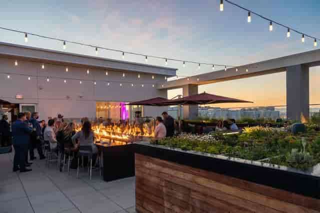 FLORA Rooftop Restaurant with string lights, perfect for evening receptions and cocktail parties.