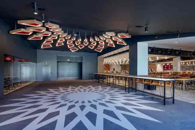 Premium Spaces in Snapdragon Stadium: modern event venue with geometric ceiling, ideal for gatherings.
