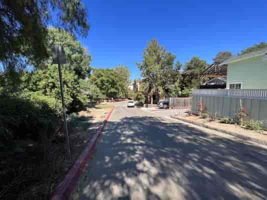 Serene tree-lined pathway at Golden Hill Recreation Center for outdoor events.