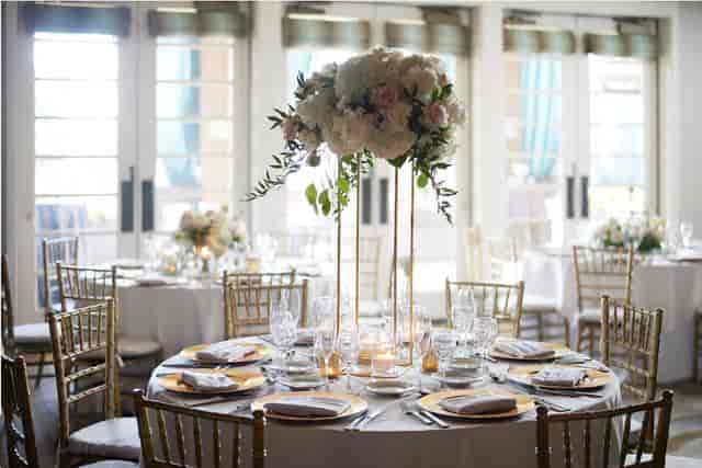 Elegant dining area with floral centerpiece at Seascape Ballroom, perfect for weddings.
