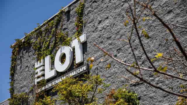 Modern restaurant exterior at The Lot, perfect for events with greenery and stylish design.