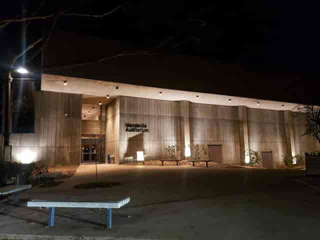 Modern East Room in Mandeville Auditorium, illuminated at night for events and performances.