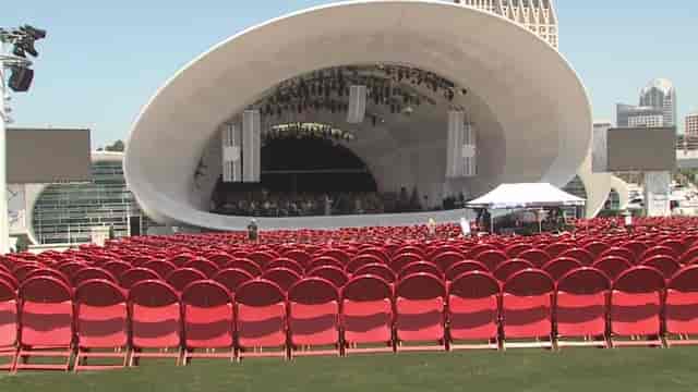 Covered Stage in The Shell with red chairs, ideal for outdoor performances and events.