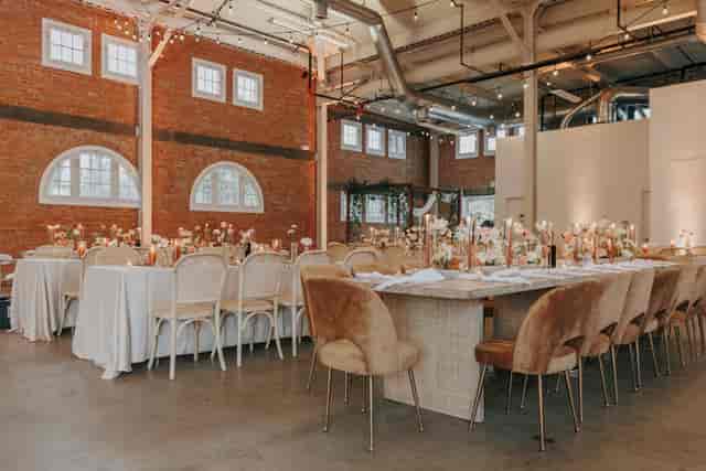 Elegant event space at The Brick, featuring floral centerpieces and warm lighting.