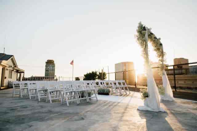 Lagunita Pavilion outdoor wedding with floral arch and sunset backdrop, ideal for events.