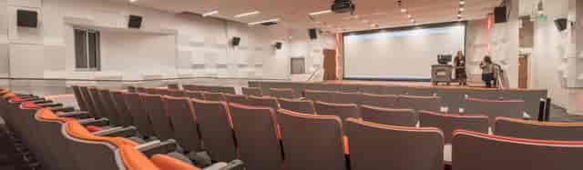 Modern auditorium with tiered seating for conferences and seminars.