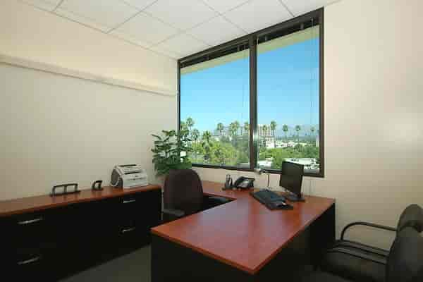 Bright private office with large windows, ideal for meetings in Premier Workspaces.
