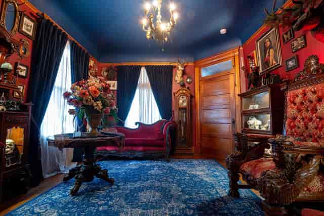 Historic Harris House dining room with red walls, ideal for corporate retreats and celebrations.