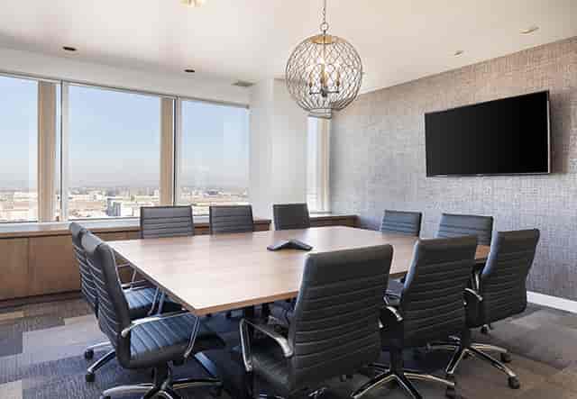 Modern conference room with large table, ideal for meetings and presentations.
