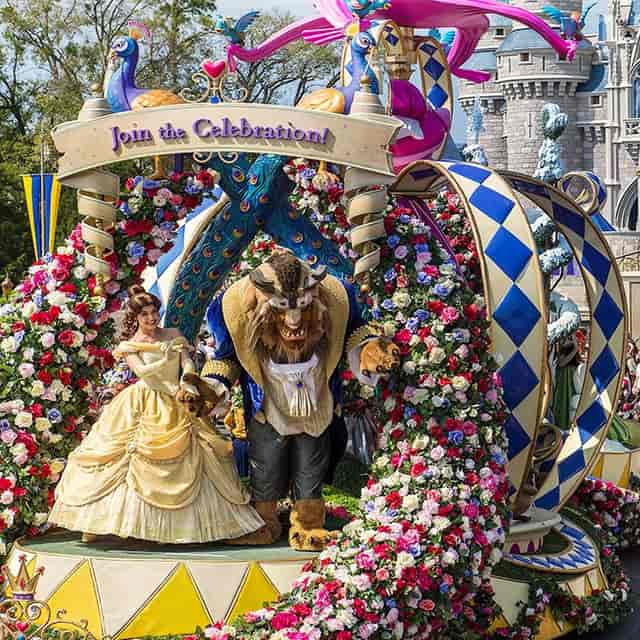 Themed event entrance with vibrant costumes and floral archway for immersive experiences.