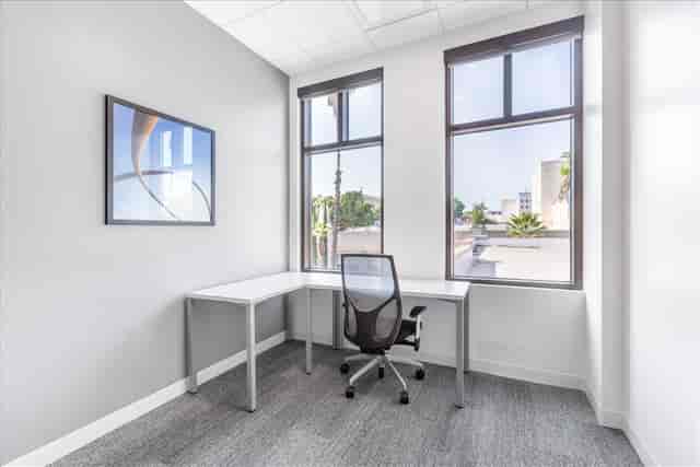 Bright minimalist meeting space with large windows, ideal for brainstorming sessions.