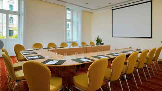 Meeting room with large table and yellow chairs at Courtyard by Marriott.