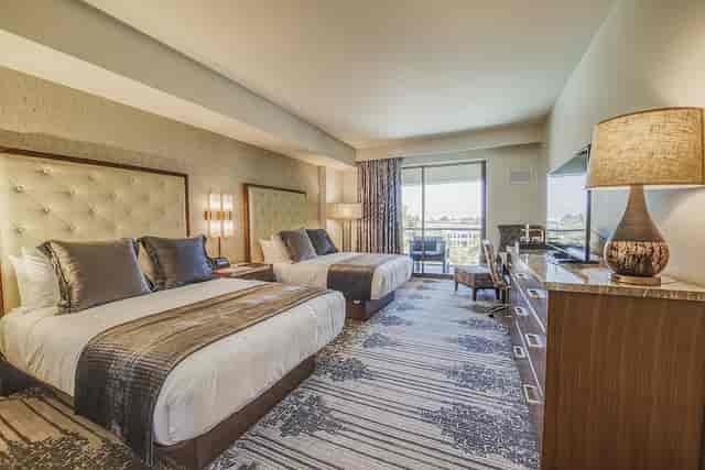 Legacy Conference Center hotel room with two queen beds, ideal for meetings and networking.