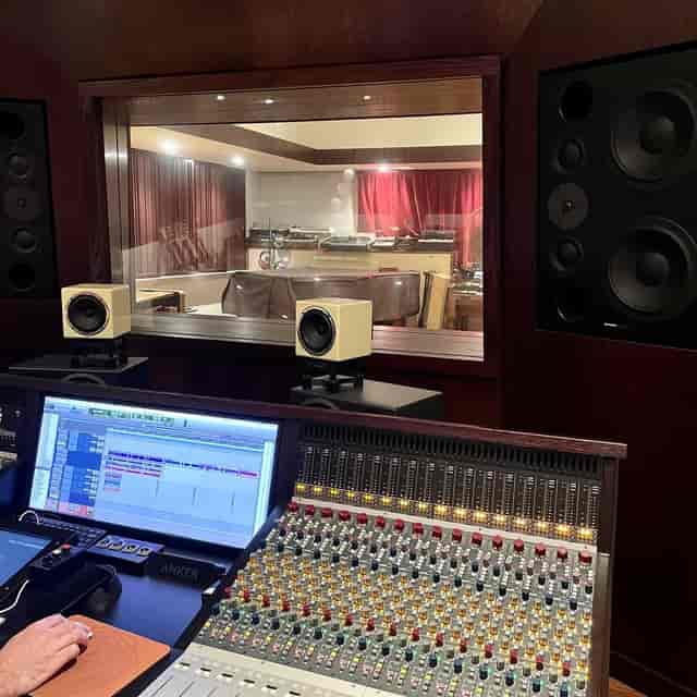 Professional recording studio with mixing console for audio production workshops.