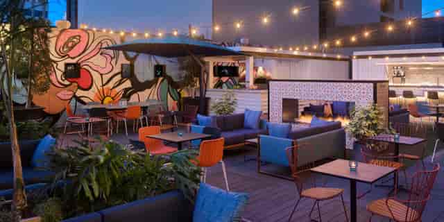 Vibrant outdoor event space at Kimpton Alma Hotel with stylish seating and fire feature.