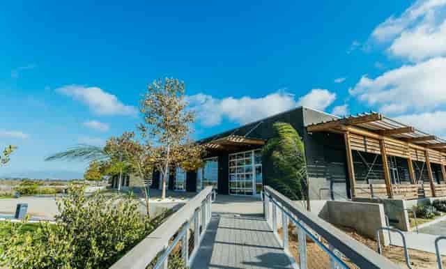 Modern event venue patio with large windows, ideal for meetings and social gatherings.