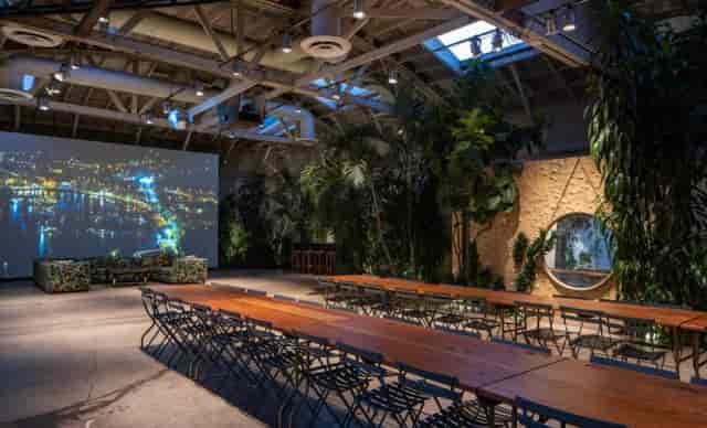 Magic Gardens event space with projection screen, ideal for presentations and gatherings.