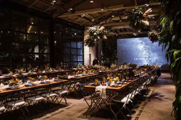 Elegant dinner setup in Millwick's Grand Hall with communal tables and ambient lighting.