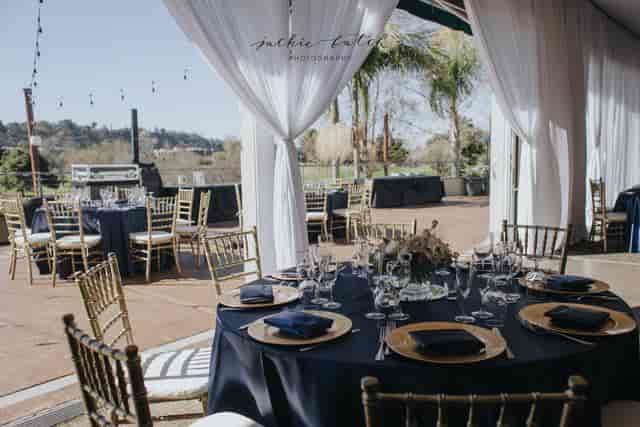 Elegant outdoor event space at Riverwalk Golf Club with navy tables, ideal for weddings.