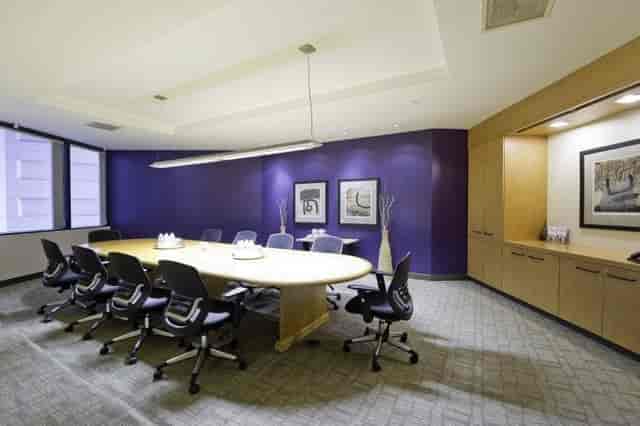 Modern conference room in Emerald Plaza with oval table, ideal for meetings and brainstorming.