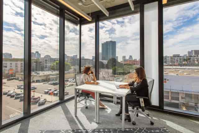 Modern meeting space with large windows in Spaces Makers Quarter, ideal for collaboration events.