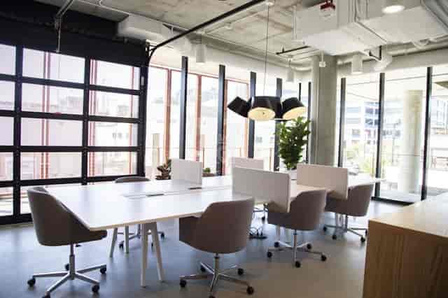 Modern meeting space with conference table and ergonomic chairs in Virtual Office Plus.