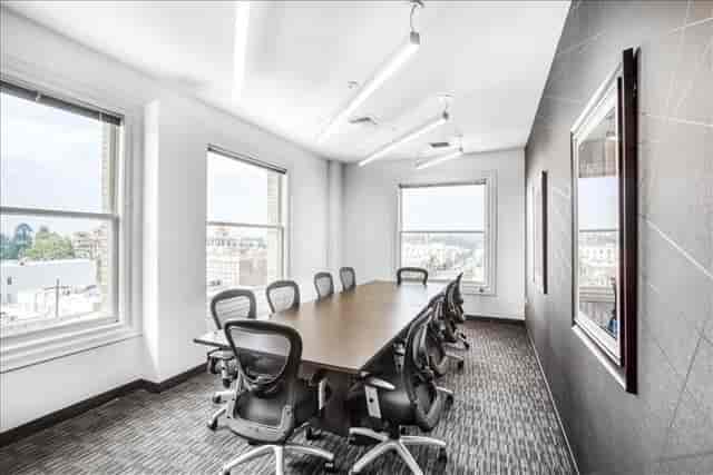 Modern conference room with ergonomic chairs and natural light for productive meetings.