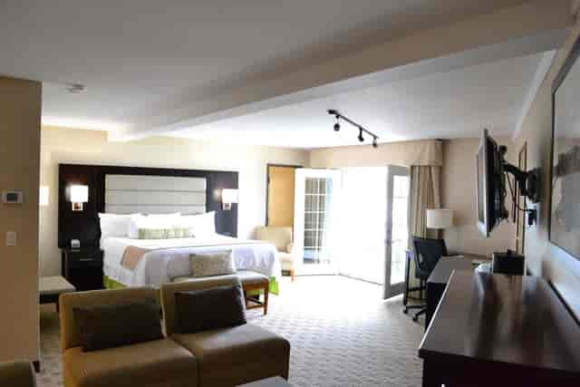 Business King Suite at LA Crystal Hotel, spacious with natural light for meetings.