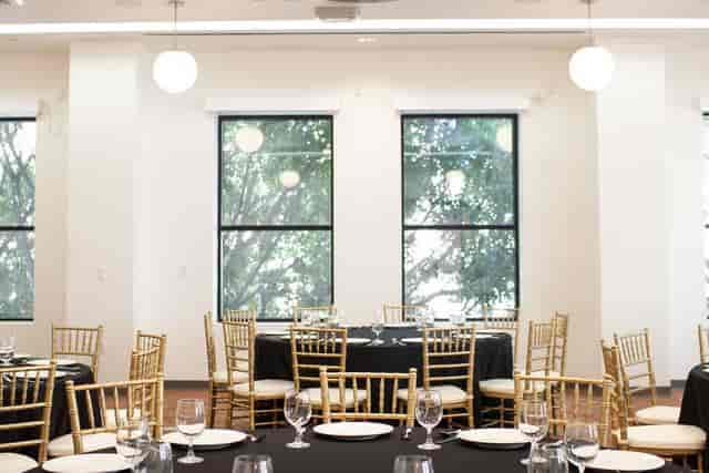 Elegant event space with black linens and gold chairs at Pasadena Hotel & Pool.
