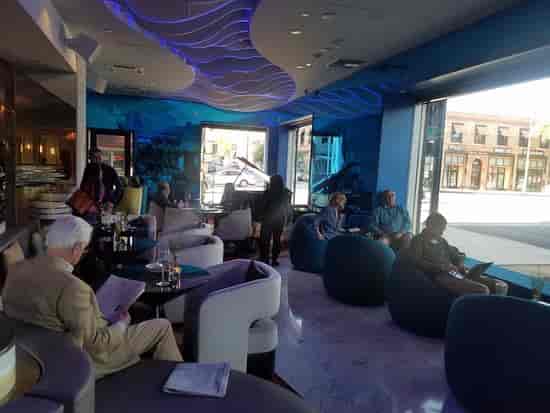 Modern lounge in Pasadena Hotel, vibrant blue decor for networking events.