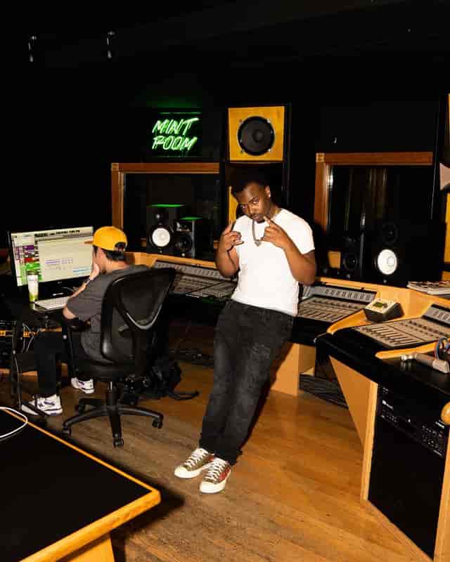 Vibrant Mint Room Studios recording studio with neon sign for music events and workshops.