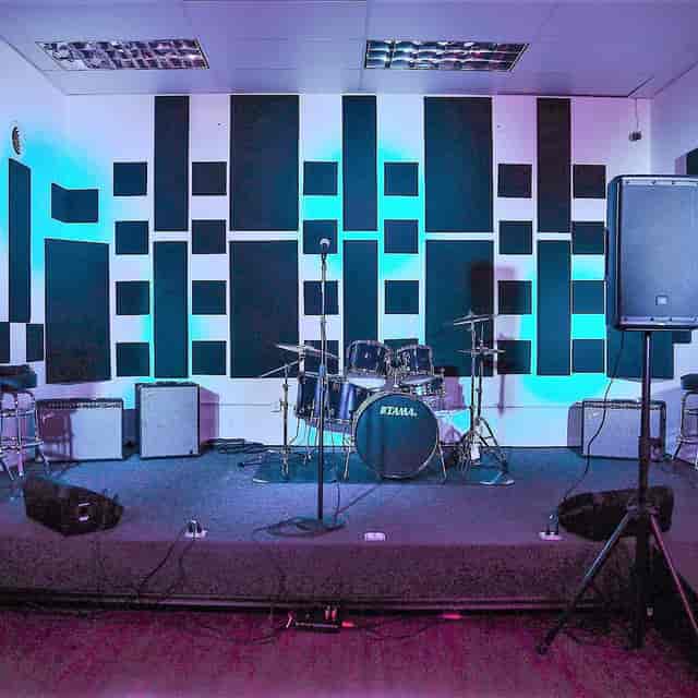 Recording studio stage setup with acoustic panels for live music events and presentations.