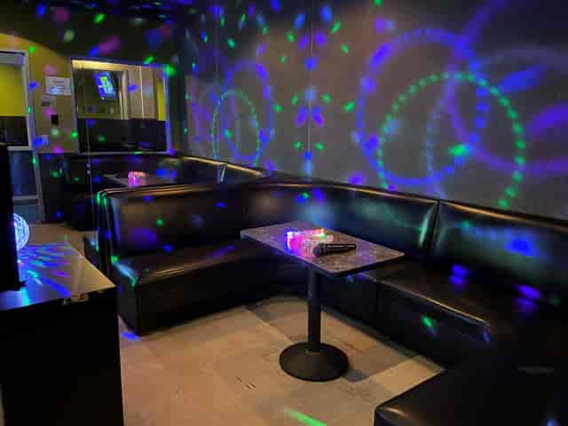 Private karaoke rooms with colorful lighting for networking and social events at XPRESS NIGHT CLUB.