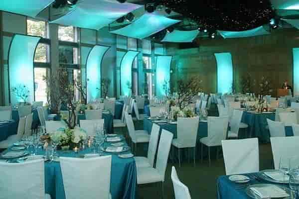 Sierra Room event space with teal tables, ideal for formal gatherings and celebrations.