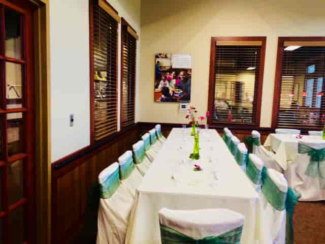 Private dining room with white linens, ideal for corporate events and gatherings.