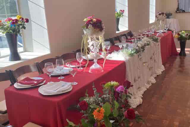 Elegant Affair Wedding Venue Suite A with red tablecloths, perfect for weddings and events.