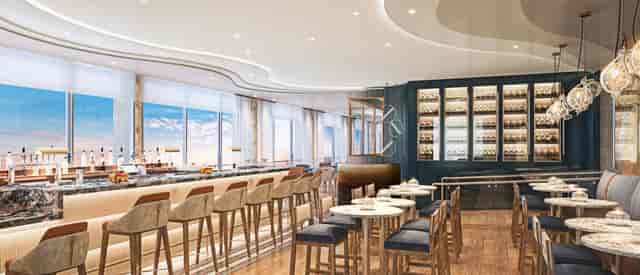 Modern event space with sleek bar and natural light for networking or social gatherings.