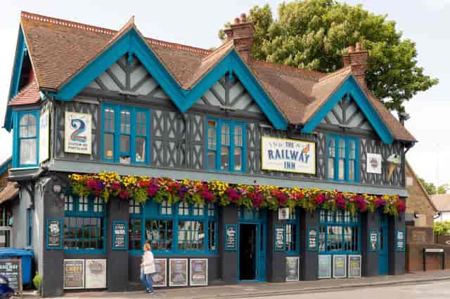 Charming Railway Inn pub with blue accents, perfect for networking events and gatherings.