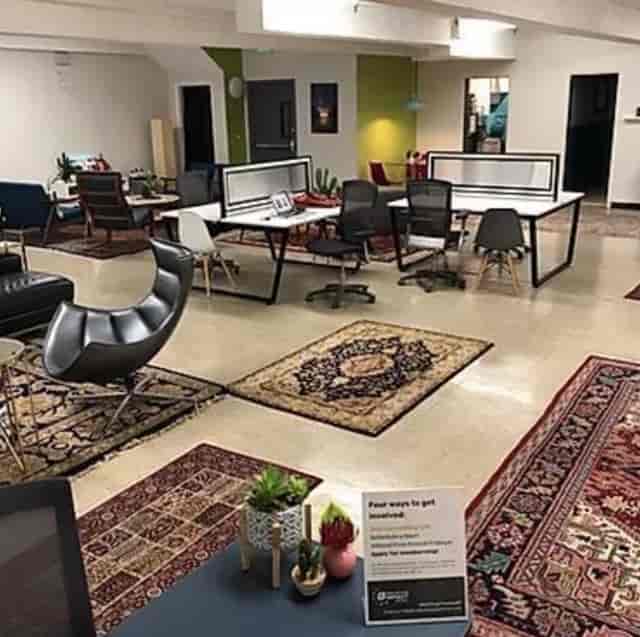 Versatile shared desk in Collective Impact Center, ideal for meetings and collaboration.