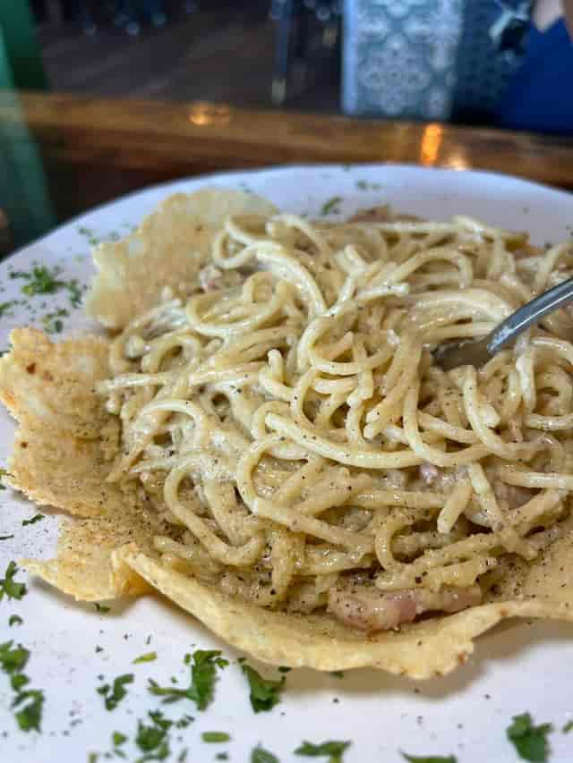 Plate of spaghetti in creamy sauce, perfect for upscale dining events and networking lunches.