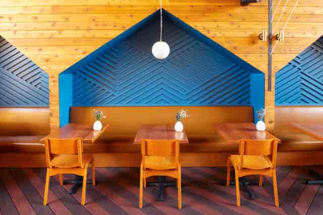 Modern Madison restaurant with warm wood tones, ideal for intimate meetings and events.