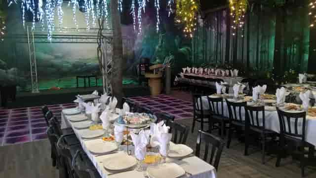 Elegant banquet hall with white linens, perfect for weddings and corporate events.