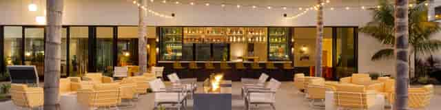 Outdoor bar area with string lights at Town and Country Resort for networking events.