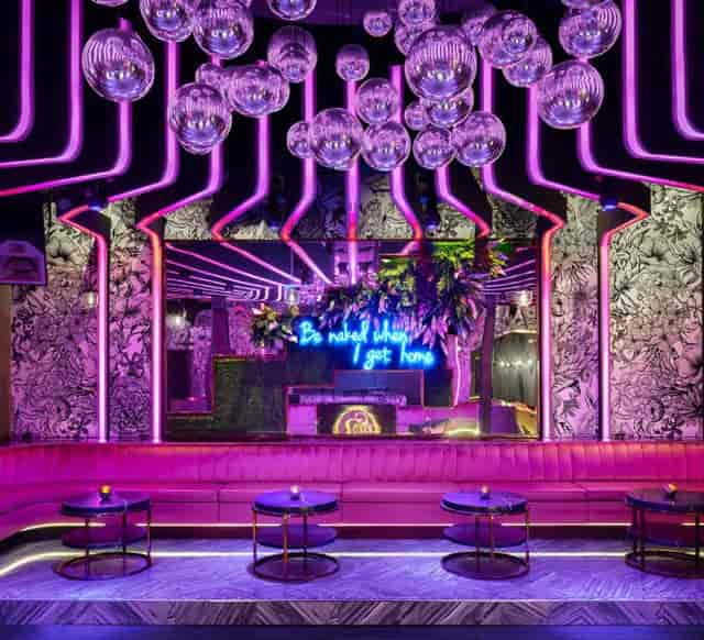 Vibrant event space with neon lighting, perfect for networking and social gatherings.