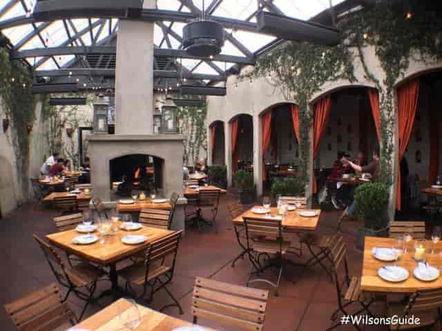 Patio dining area with glass roof, perfect for intimate gatherings and events.