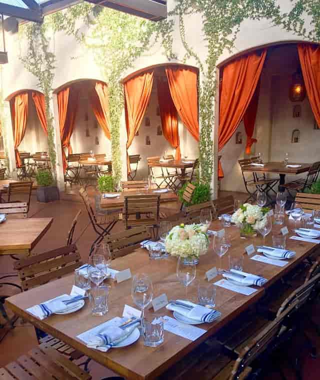 Patio dining area with elegant drapes, perfect for intimate gatherings and events.