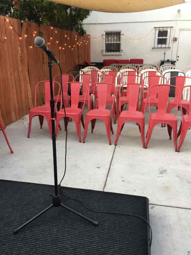 Outdoor patio with red chairs for an intimate gathering in Los Angeles, perfect for networking.