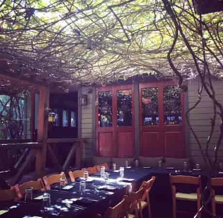 Cactus Garden at The Raymond 1886: cozy outdoor meeting space with rustic decor.