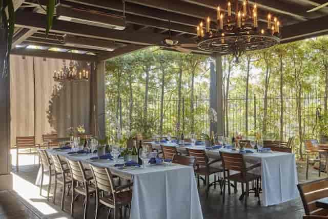 Elegant sunroom event space with chandeliers, perfect for intimate gatherings and meetings.