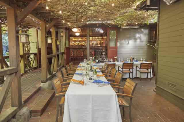 Outdoor dining at Fireside Terrace, elegant tables for corporate events and gatherings.